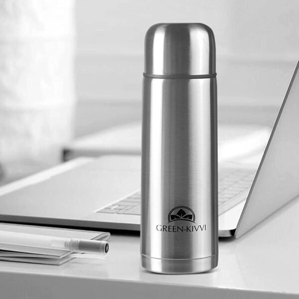 double wall vacuum flask on a table with Laptop