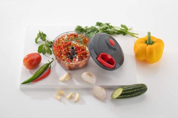 Manual chopper with veggies on table