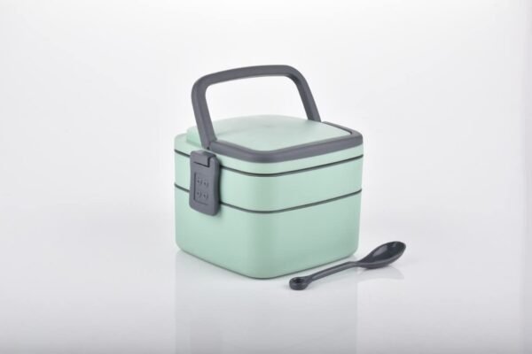 plastic lunch box with spoon on white background