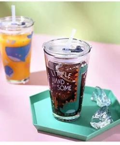 Two pieces of glass sipper mason jar with straw filled with soft drinks on table