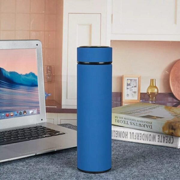 Blue color water bottle on table with laptop and book