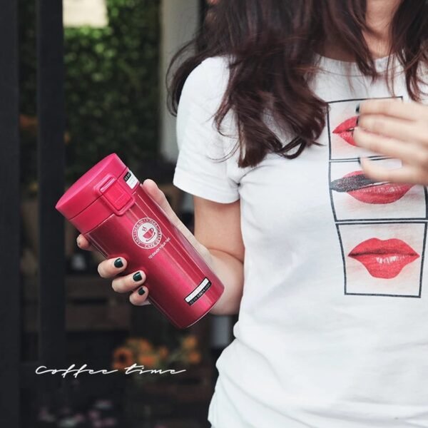 Pink color insulated coffee mug in girl's hand
