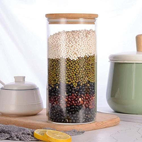 Transparent glass jar having cereals in it on decorative background