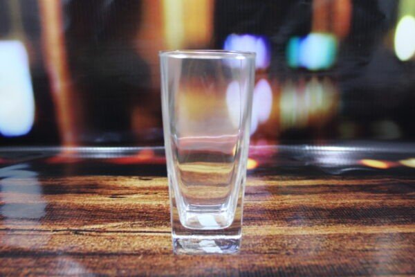 Empty premium glass water glass on decorative background