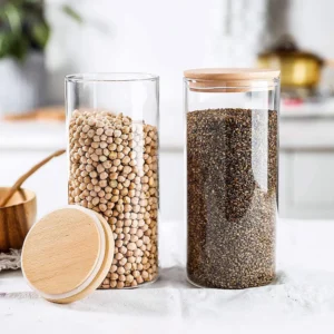 Two pieces of glass storage container on white background having cereals in it