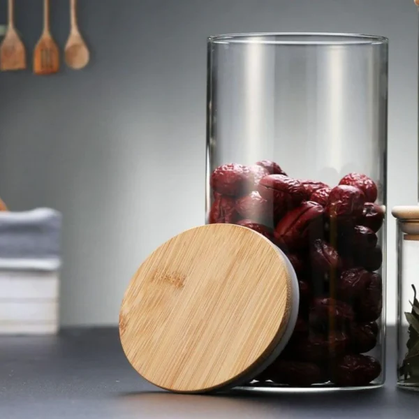 Glass storage container jar with bamboo lid having dry fruits in it