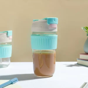 Blue color glass tumbler filled with tea on decorative background