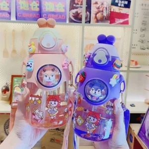 Blue and pink color plastic sipper bottle for kids on decorative background in hand