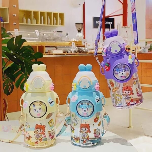 Different color kids transparent plastic sipper on decorative background with hangable strap and stickers