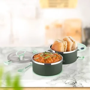 Stainless steel insulated double layer lunch box green color filled with food on decorative background
