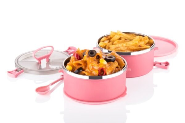 Pink color double layer lunch box filled with food on white background