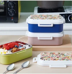 Assorted color flower print lid filled with food with spoons on table