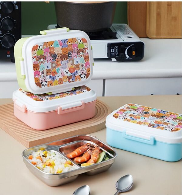 Partition insulated lunch box filled with food assorted colors on table