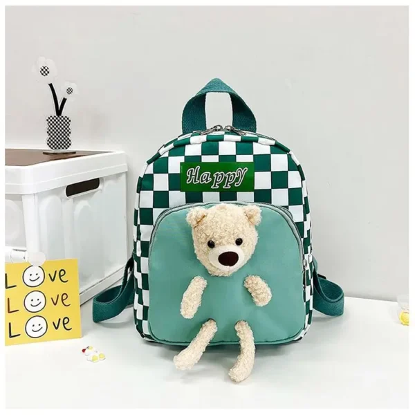 Green color kids school bag with check print and teddy toy on table