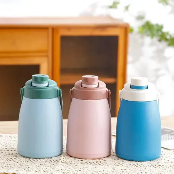 Mix color glass water bottle for kids on decorative background