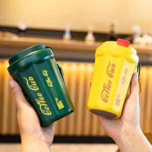 Green and yellow color of insulated coffee cup in hand