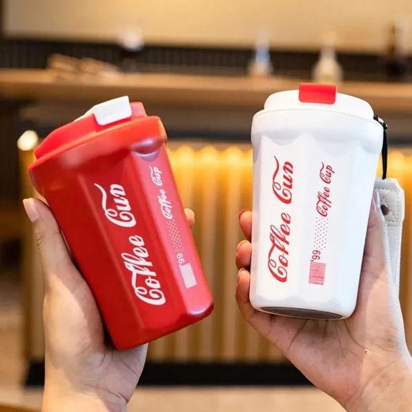 Red and while color in insulated cola coffee cup in hand