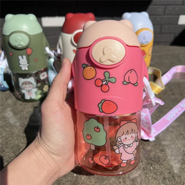 Pink color plastic sipper with kawaii stickers in hand