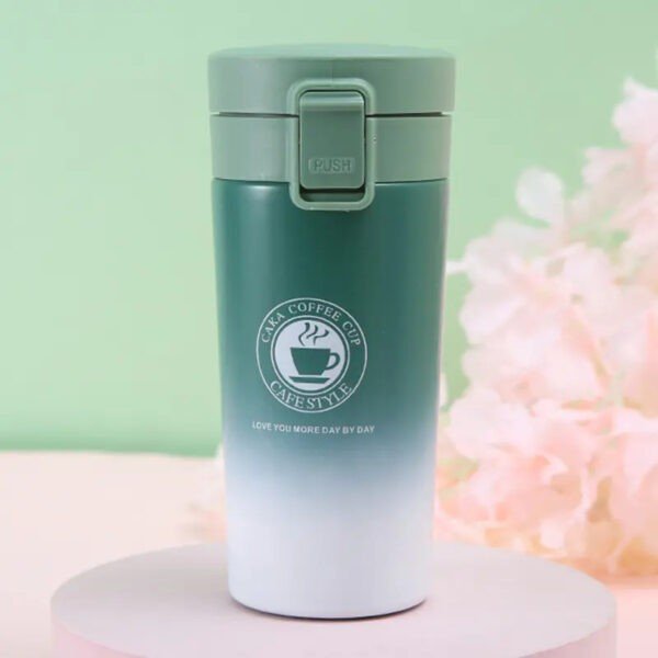 Greenish color dual shade insulated double wall coffee mug on decorative background