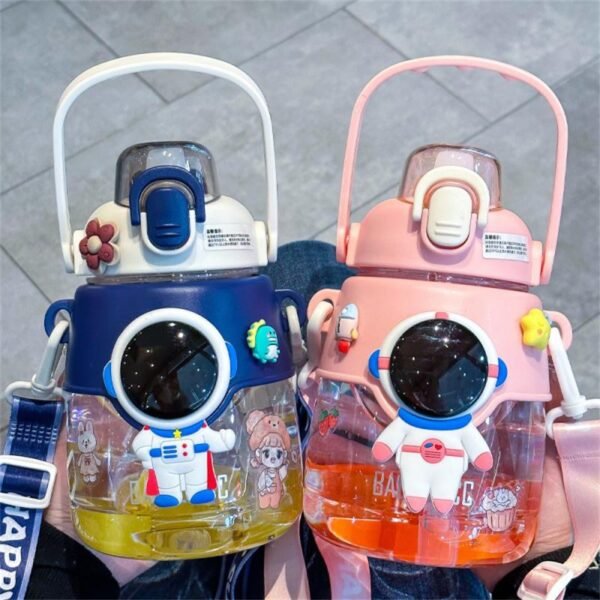 Two pieces of different colors space sipper bottle for children in hand