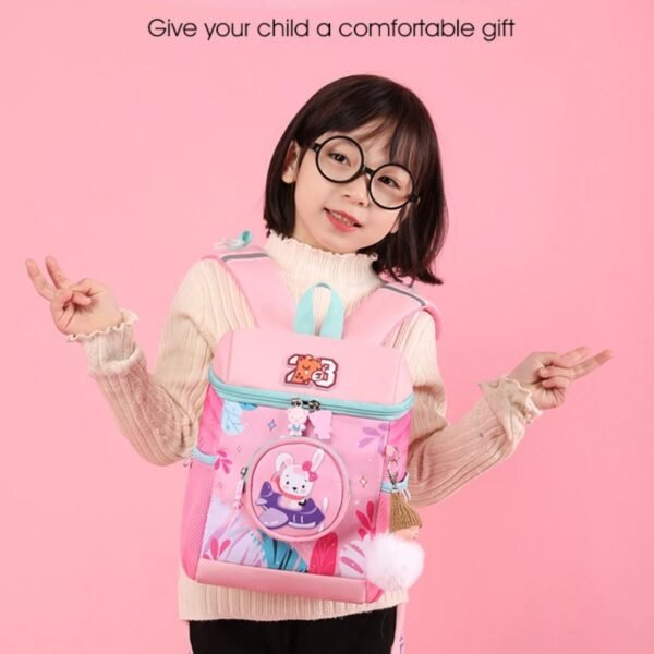 Girl hanging pink color backpack on colorful background
