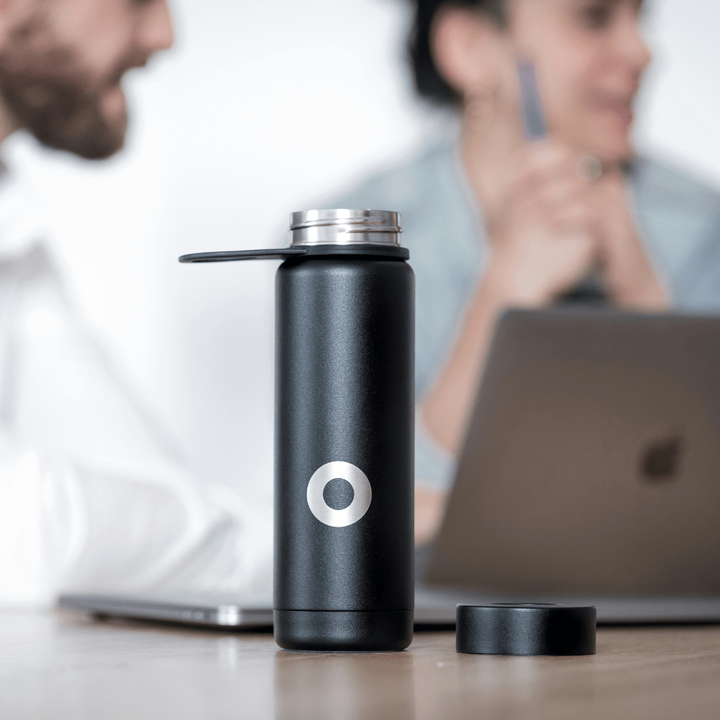 Stainless steel black color water bottle with lid on office table