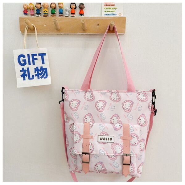 Hello kitty character print pink color tote bag hanging using wooden clips on wall