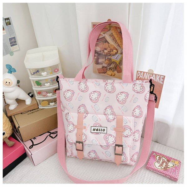 Pink color hello kitty character print tote bag on decorative background with adjustable strap