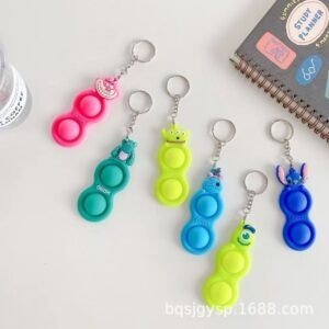 Silicone Pop it Key Chain mix Colors on decorative background