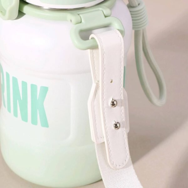 Close up of the white adjustable strap and buckle mechanism attached to a white and min green gradient water bottle, highlighting its portability features and partial 'DRINK' text.