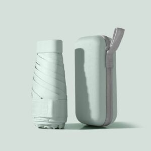 Folded compact umbrella standing next to its matching protective case in pastel blue.