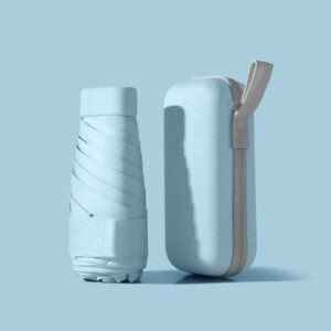 Folded compact umbrella standing next to its matching protective case in pastel blue.