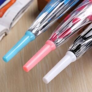 Close up of light blue, pink and white handles of transparent umbrellas.