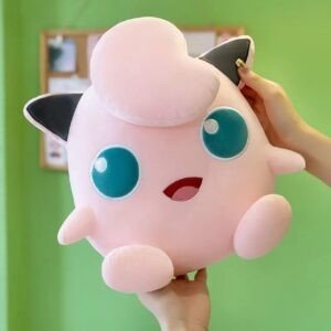Jigglypuff plushie held in hands. Pink Pokemon character stuffed toy. Cute anime soft toy gift.
