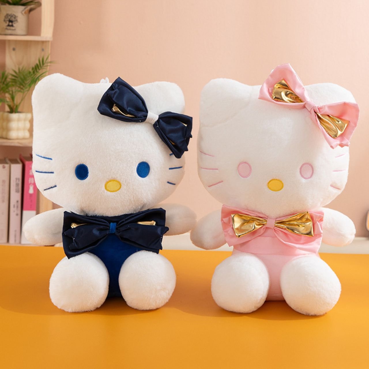 Two 45 cm Hello Kitty plush toys in assorted colors with navy blue and gold bows