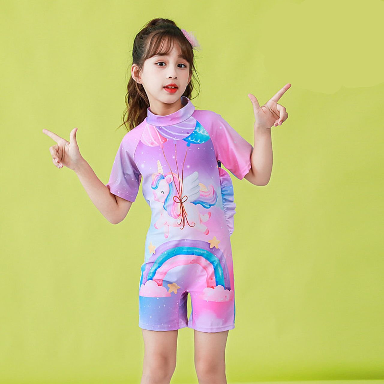 Young girls wearing purple and pink gradient kids swimming suit with unicorn and rainbow cartoon print