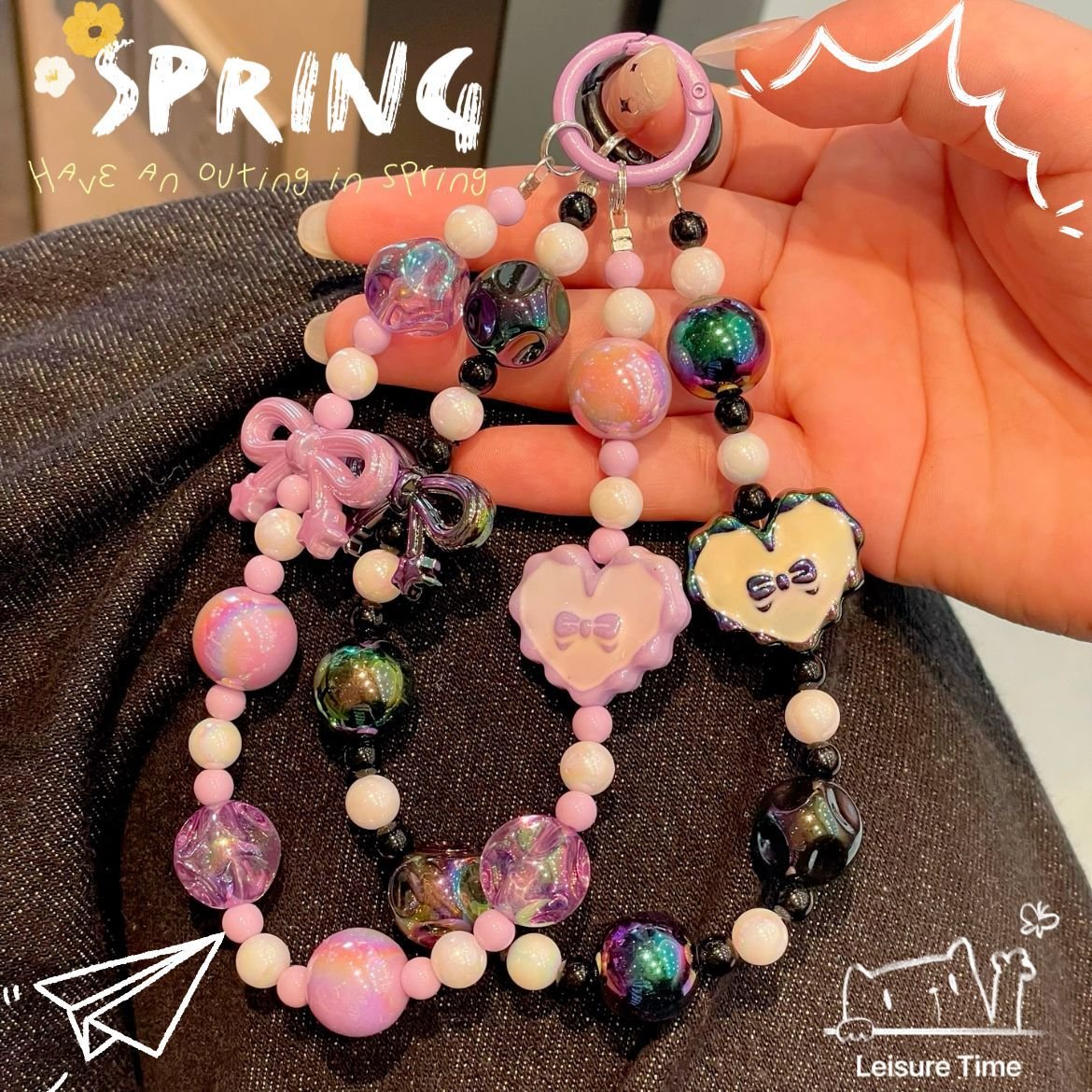 Colorful acrylic beaded mobile phone charm with a 'Spring' printed backing card and floral accents.