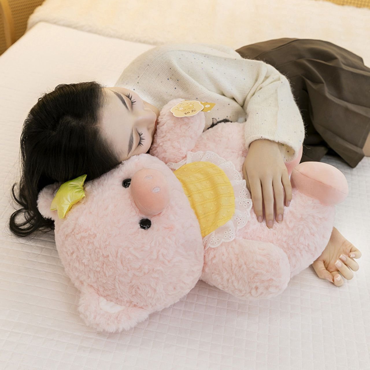 Woman sleeping peacefully while hugging a large pink pig plush toy.