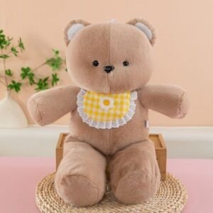 Cute brown bear plush toy wearing a yellow checkered bib